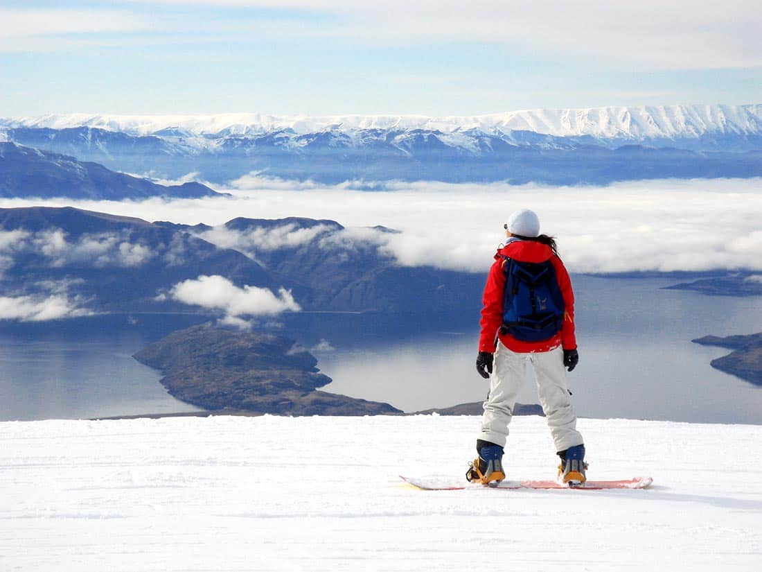 snowboarder takes in the awesome view from cardrona new zealand