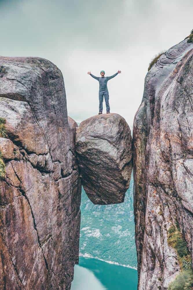 The Hanging Stone in Norway! Not sure I would be brave enough to walk on this.  What about you? Seven Sister Falls. in one of the most famous fjords in Norway! Norway is one of the most breathtakingly beautiful countries in the world and these photos prove it! So amazing! Here are some of the top places to see in Norway. #norway #norwayphtoos #norwayphotography #avenlylanetravel #avenlylane #europe #travelinspiration #beautifulplaces 