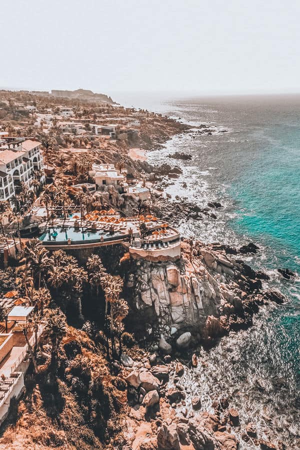 Amazing resorts on the rocky coastline of Cabo San Lucas! Planning a trip to Mexico and wondering which beach vacation you should consider - Cabo or Cancun? If you are wondering which is better than click through to www.avenlylanetravel.com and check out the major differences between the 2 beach destinations in Mexico. #cabo #mexico #cancun #avenlylane #avenlylanetravel
