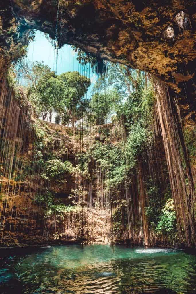 Cenote Ik Kil is so close to Chichen Itza that it is known as the Chichen Itza Cenote. This picturesque cenote is huge and features cenote diving. #cenotes #mexico #chichenitza #traveldestinations #travelinspiration #avenlylane #avenlylanetravel #beautifulplaces