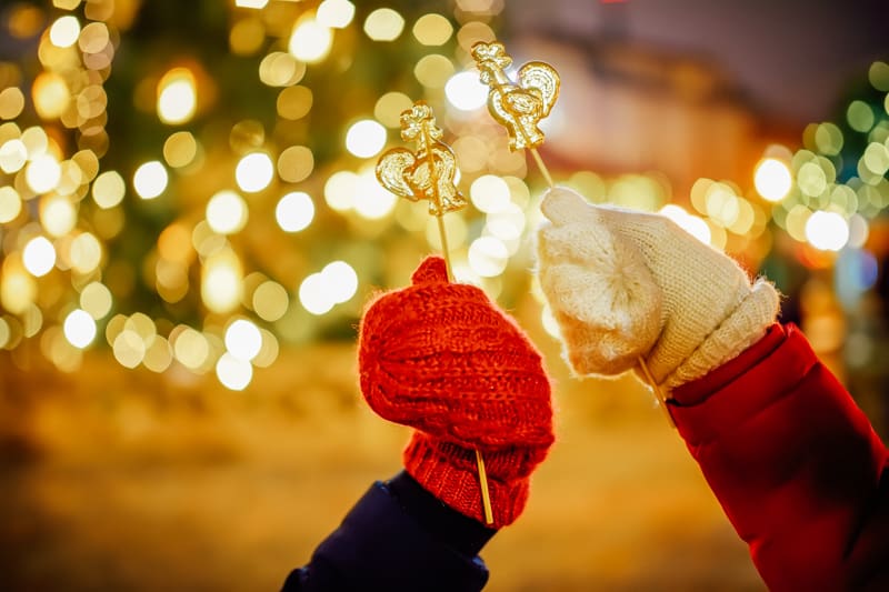 Kids holding lollipops in Riga Christmas market