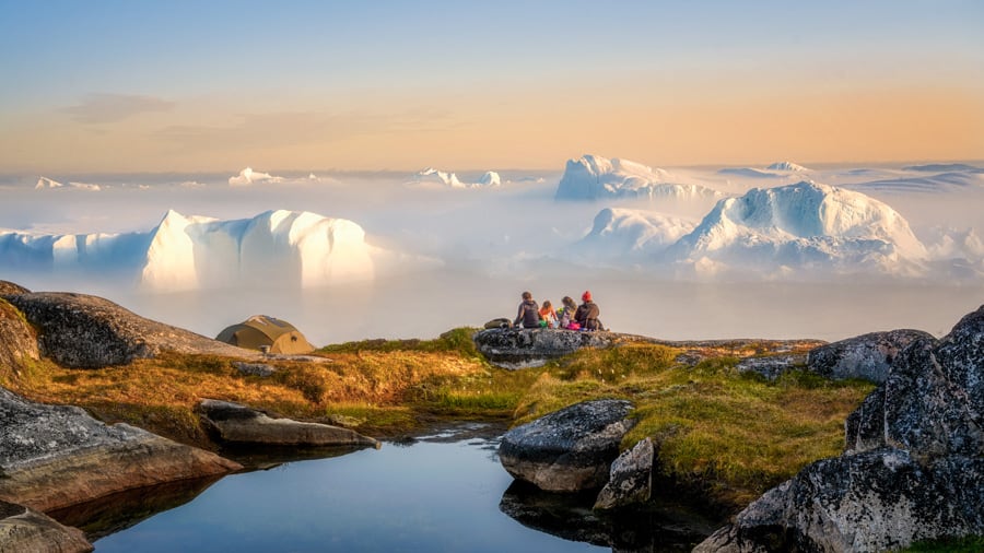Midnight sun in Greenland with glaciers in the background