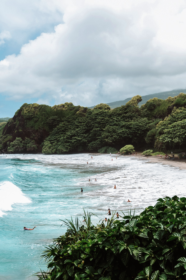 Surfers on remote Hamoa Beach