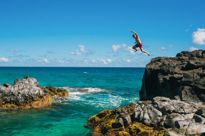 Dangerous cliff jump on Lumahai Beach, island of Kauai.