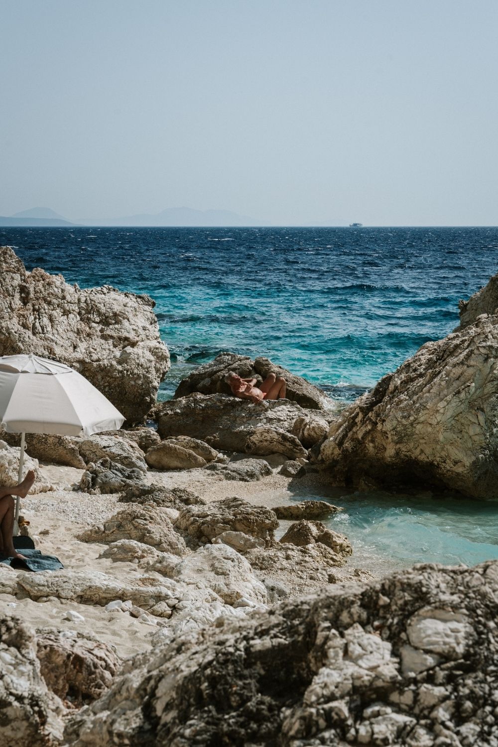 People sun bathing at Agiofili beach