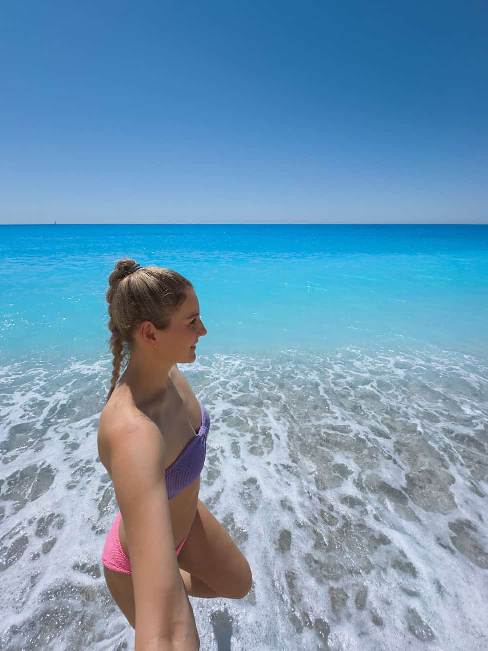 Girl swimming at Egremni Beach in Lefkada, Greece