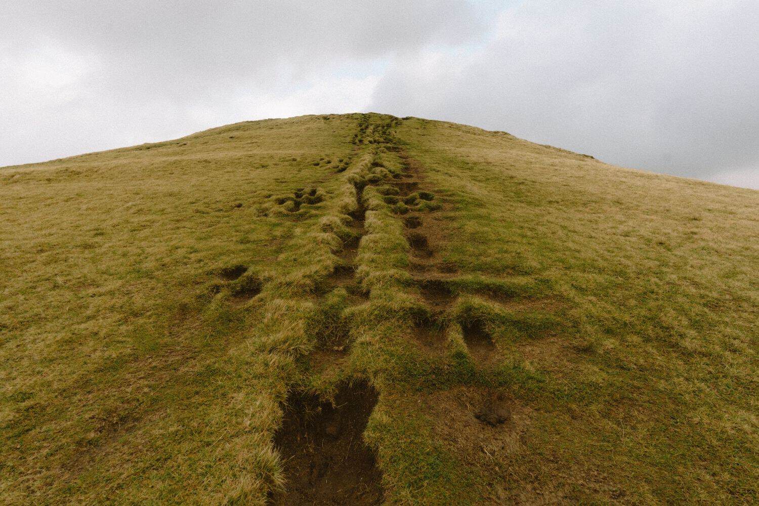 Grassy trail leading up the final hill toward the Klakkur viewpoint in the Faroe Islands.