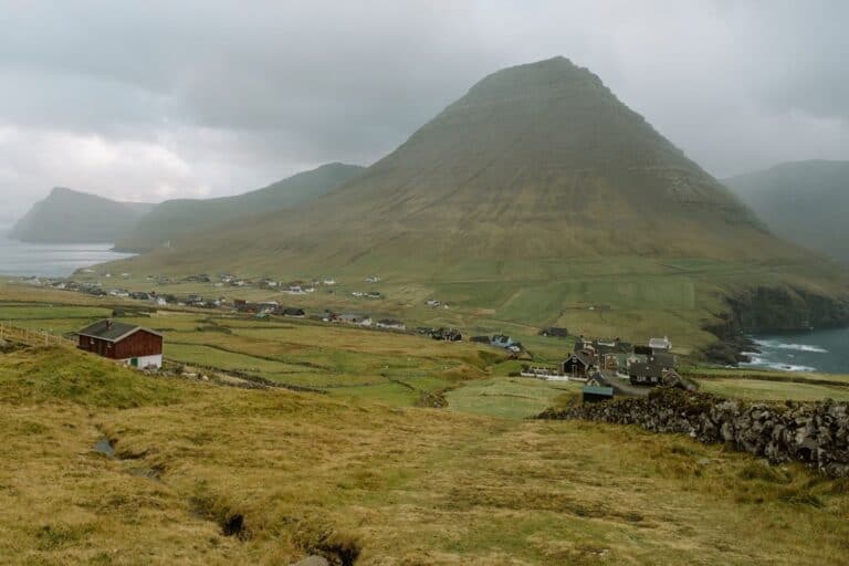 Viðareiði village sitting below a massive mountain on Viðoy Island in the Faroe Islands