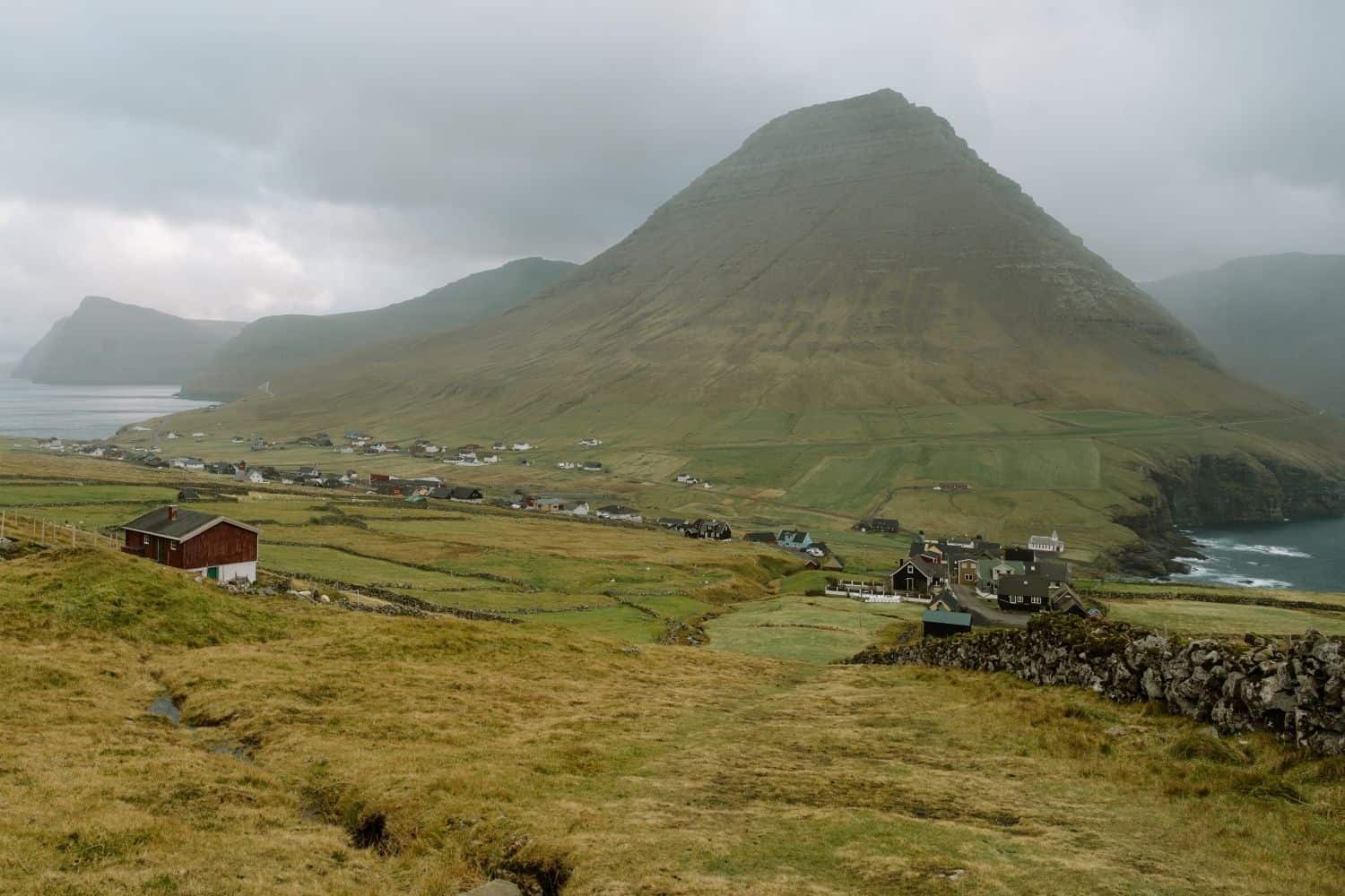 Viðareiði village sitting below a massive mountain on Viðoy Island in the Faroe Islands